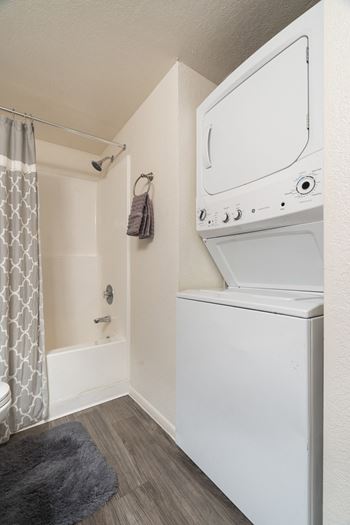 a bathroom with a washer and dryer in it